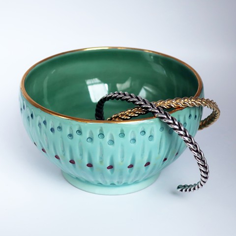 Porcelain bowl with braid cuff bracelets.