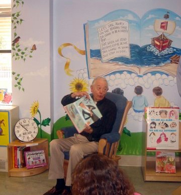 children's book author Lloyd Moss reading at the opening ceremony