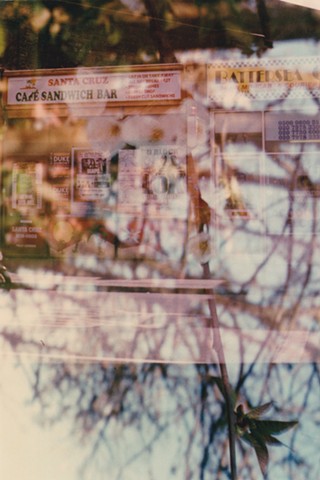 A lo-fi multiple exposure film photo of a vintage cafe sandwich bar in Battersea, London, England, with cherry tree flower blossoms.
