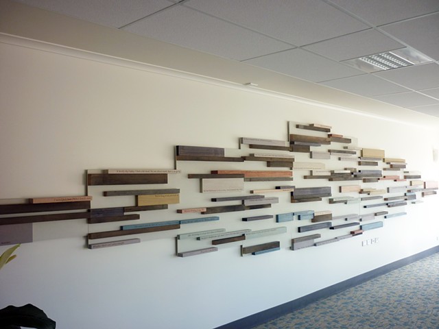A sculptural wall relief featuring laser engraved timber