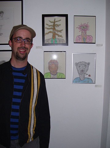 Photograph of artist Christopher Stanton with his drawings