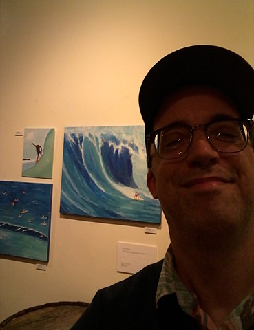 Artist Christopher Stanton with his acrylic surfer paintings at The Five Elements