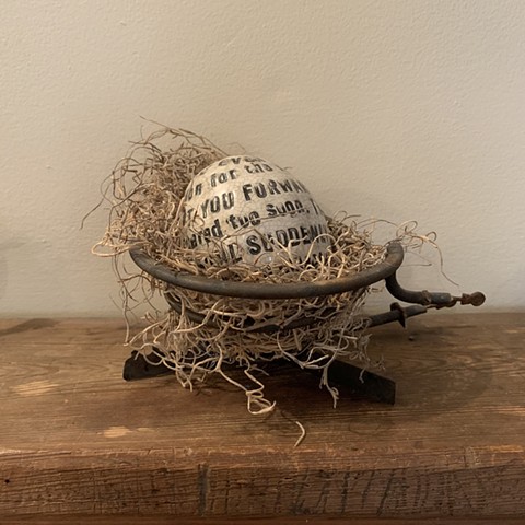 Text egg in stove element with Spanish moss