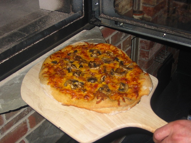 The first pizza coming out of my heater's black oven.