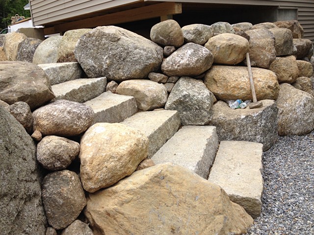 Cascading stone around antique granite steps