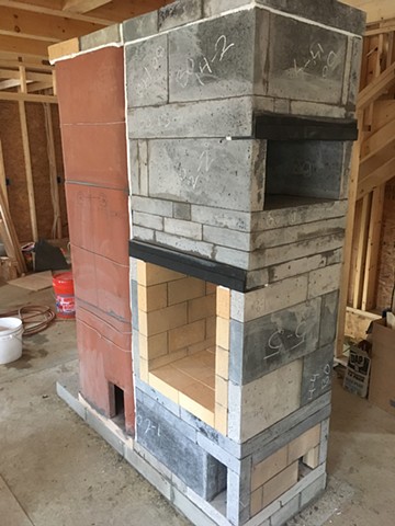 The core of this heater is custom cast refractory by Solid Rock Masonry, and 24" clay tiles.