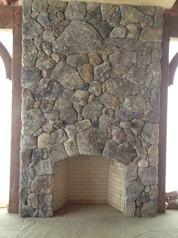 Stone fireplace facing in to the porch.