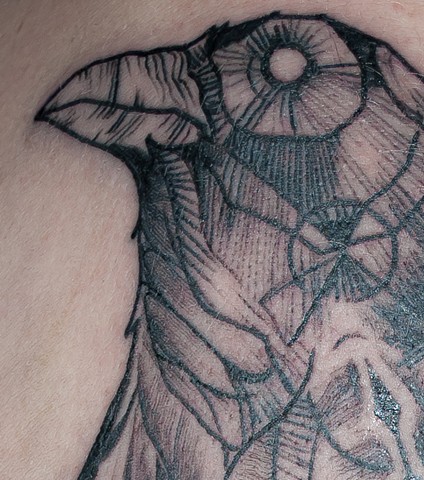 detail of an abstract raven tattoo by chris lowe of naked art tattoos