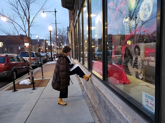 Lori reviewing Li-Ming Hu's submission, conveniently located in the windows on the other side of the Co-Prosperity Sphere
