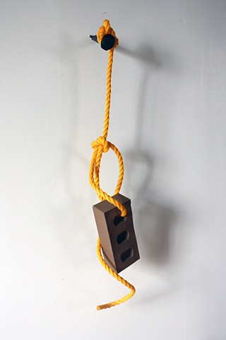 sculpture of sandpaper brick on a rope by Rena Leinberger