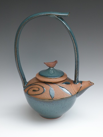 Teapot with tall handle, turquoise glaze, spirals, leaves and bird on lid
