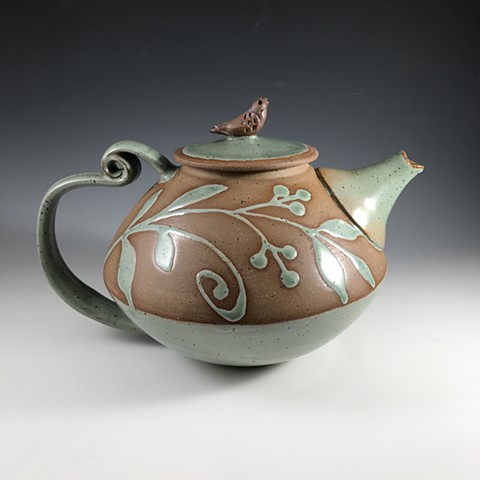 Curled back handle teapot