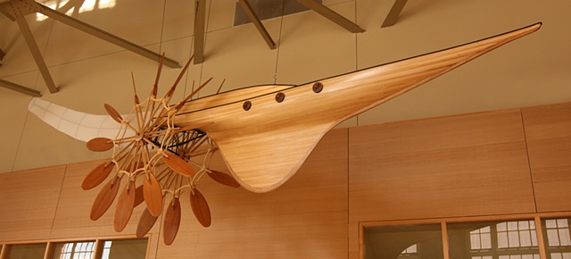 This large-scale ceiling hung mixed-media sculpture is constructed using wood, steel, and aircraft fabric.