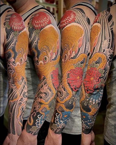 A traditional Japanese full sleeve featuring a gold octopus and colorful chrysanthemum flowers