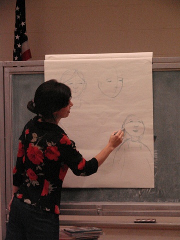 Rene demonstrating how to draw a character from the book Papi's Gift