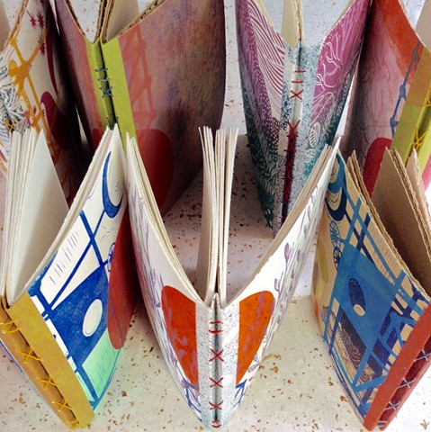 Colorful handbound sketchbooks with hand-sewn spines