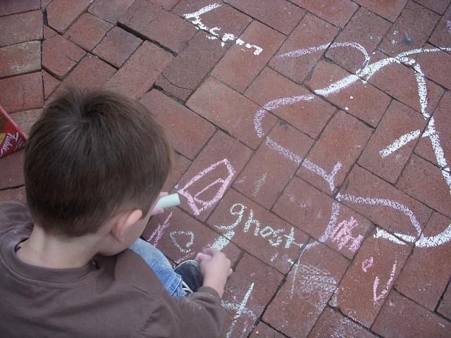 Visitors to The Box, playing with sidewalk chalk and telling ghost stories.