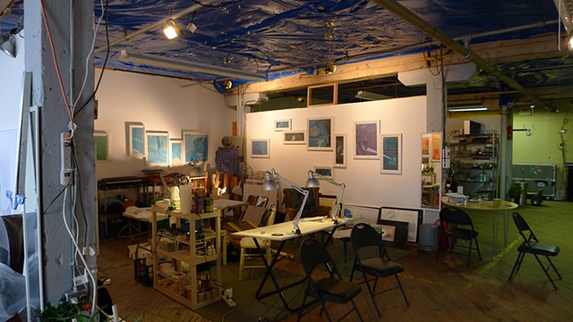 View of artist studio workplace in Chicago with colorful, multi-panel paintings by Steven L. Jones
