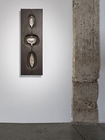 wall sculpture comprised of cast aluminum, wood, graphite, and sewing needles by Mary Meyer