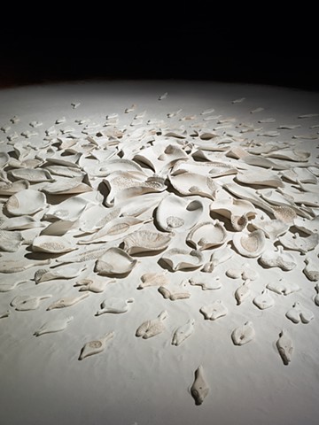 detail of floor installation by Mary Meyer comprised of painted ceramic and sand
