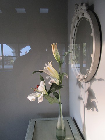 Flowers in entry.  Arches reflected in the glass door.
