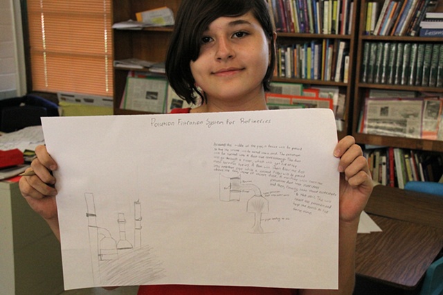 Baker Middle School student with her drawing for a "pollution filtration system" for the nearby refineries, Corpus Christi, Tx.