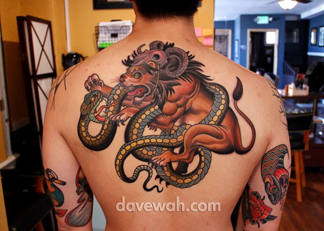 lion fighting snake tattoo by dave wah at stay humble tattoo company in baltimore maryland the best tattoo shop in baltimore maryland