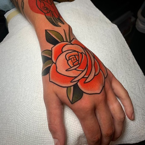 rose tattoo on hand tattoo by tattoo artist dave wah at stay humble tattoo company in baltimore maryland the best tattoo shop in baltimore maryland