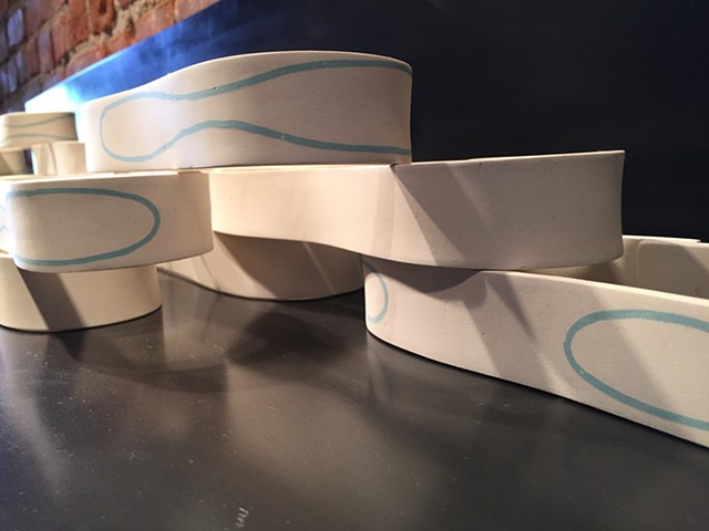 Ceramic forms with inlayed slip, and stacked. A study in water movement.