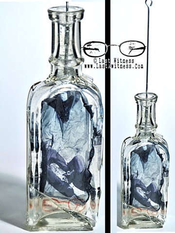 photo emulsion suspended in resin casted inside vintage medicine bottle with tattoo needle hanger