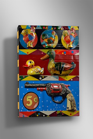 Vintage toys and lithographed tin are assembled to create the look of an old shooting gallery