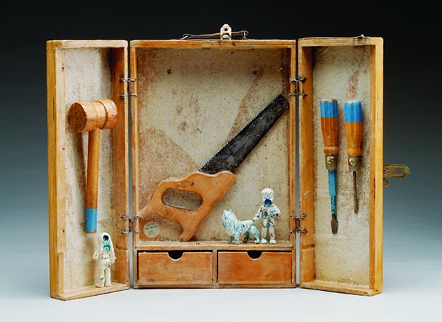 porcelain figures with glass inclusions, stain and glaze; handmade mica paper; vintage child's toolbox and tools, encaustic