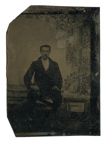 [seated man in black]