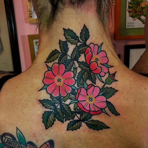 Colourful bright pink colour traditional or neo-traditional tattoo in feminine style back of neck with detail made by Jenny Boulger in Toronto Canada