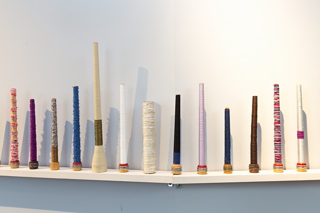 wooden bobbins wound with string