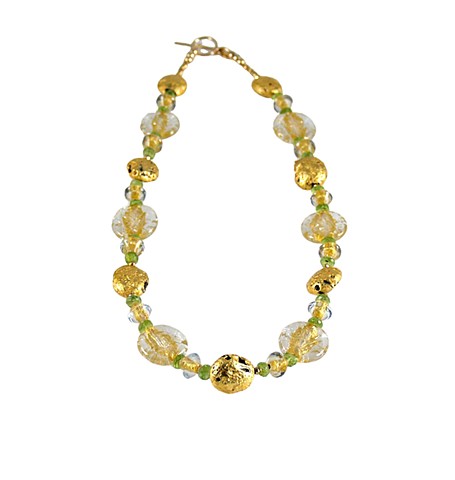Crystal Glow Peridot and Gold Necklace, Hand gilded 23-Karat gold leaf on lava, peridot and gold necklace, Czech Glass, pyrite, and 23-karat gold-filled toggle clasp with the artist’s signature tag. The necklace measures 18.5”