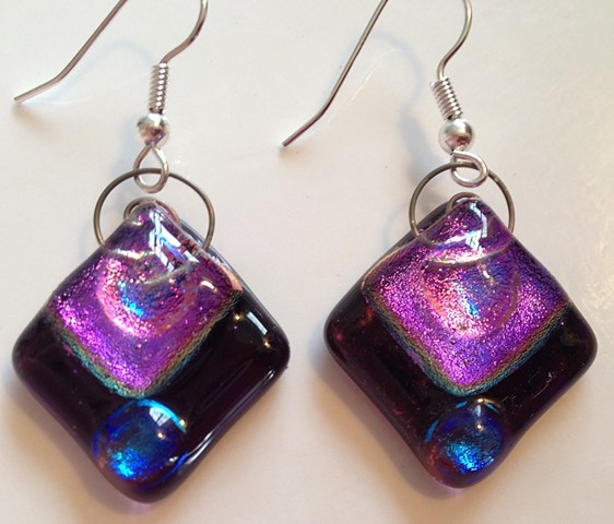 Purple Diamond Delights! 

Details:
very purple glass with sparkly dichroic glass, with spiral wire tops, to hang from hypoallergenic ear wires;
about 1" x 1"".
