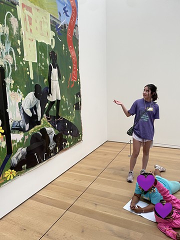 Story K. presenting a Kerry James Marshall painting to campers