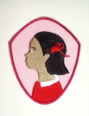 Badge featuring Girl's profile. Can be sewn onto any clothing or fabric accessory.