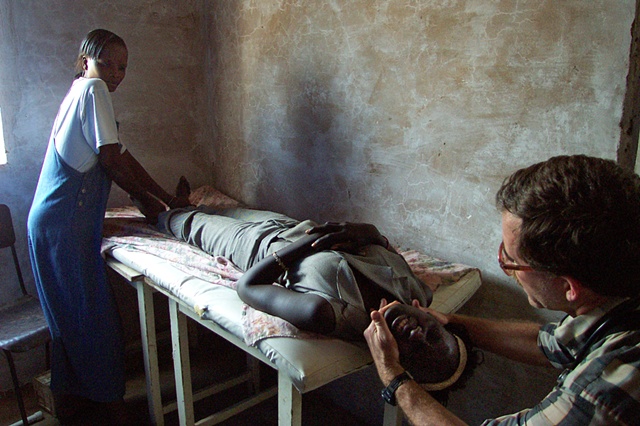 Missionary doctor making spinal adjustment - Mbakhe