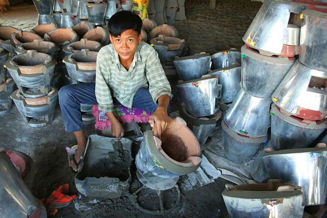 Boy working in family pottery business in the pottery village near the city of Kampong Chhnang
