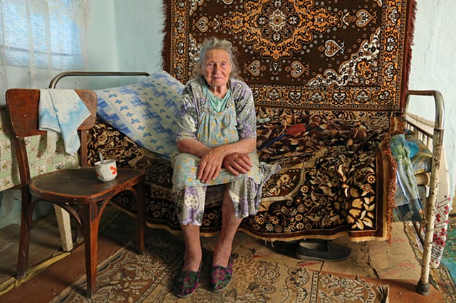 Olya in her earthen-floored home