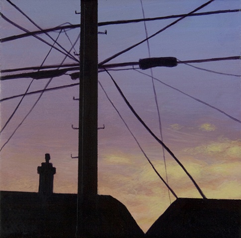Sunset of telephone pole, wires, houses.