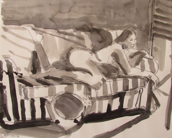woman on stomach, striped couch, heater in foreground