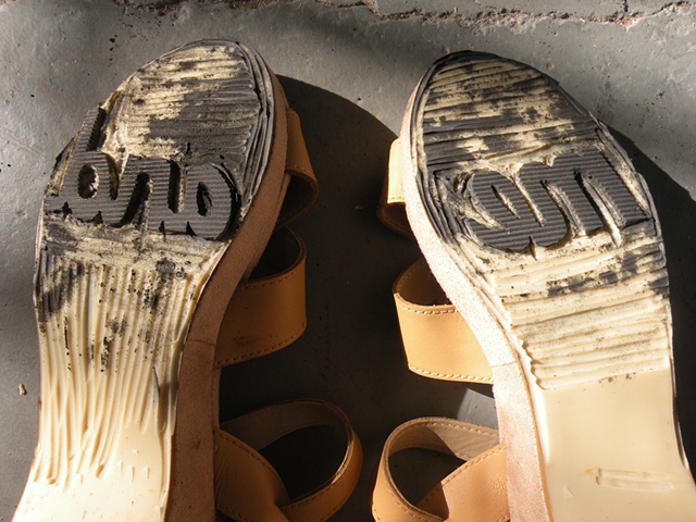 Carved shoes with the words "me" and "and" on the soles. By Courtney Kessel