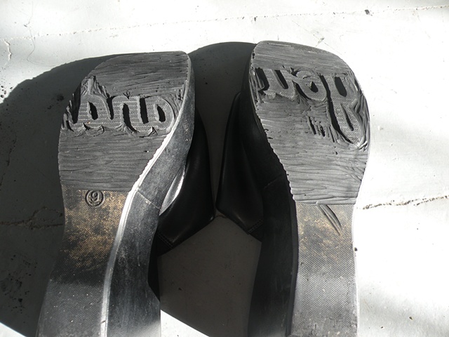 Carved shoes with the words "you" and "and" on the soles. By Courtney Kessel