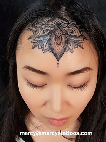 mandala forehead tattoo