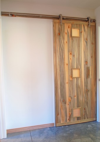 Modern sliding barn door made with blue pine designed and handmade by Andrew Traub.