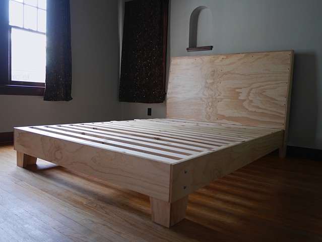 Modern plywood bed frame designed and built by Andrew Traub