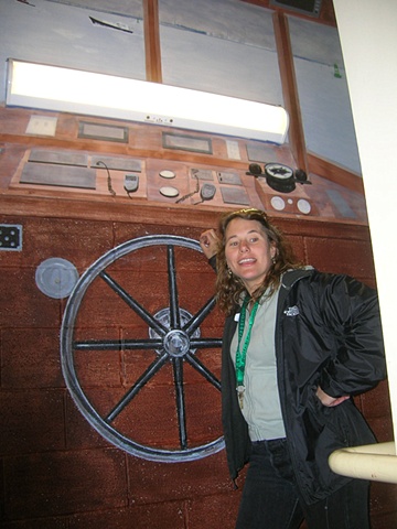 Artist in front of unfinished wheelhouse